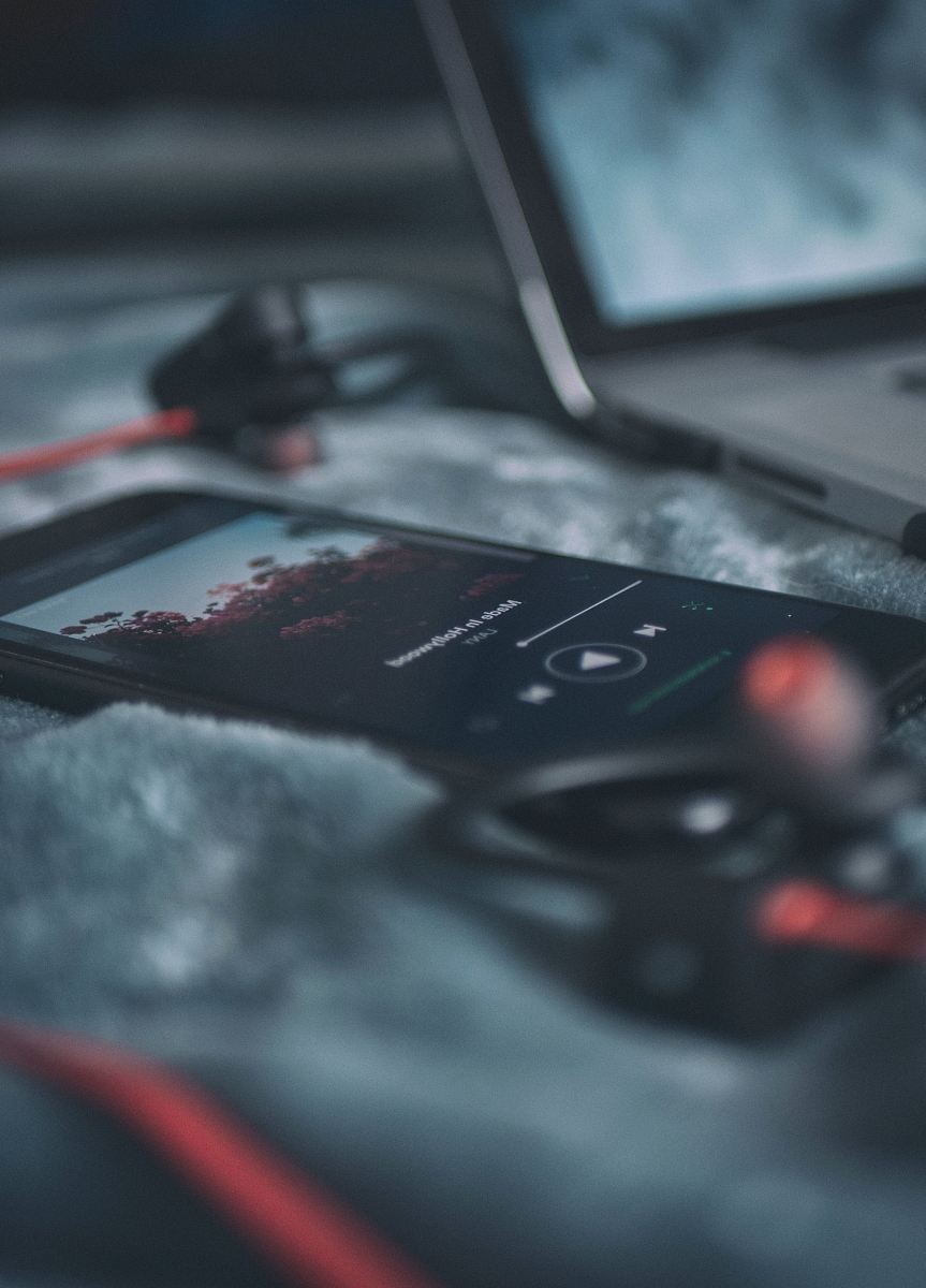 black smartphone on gray textile